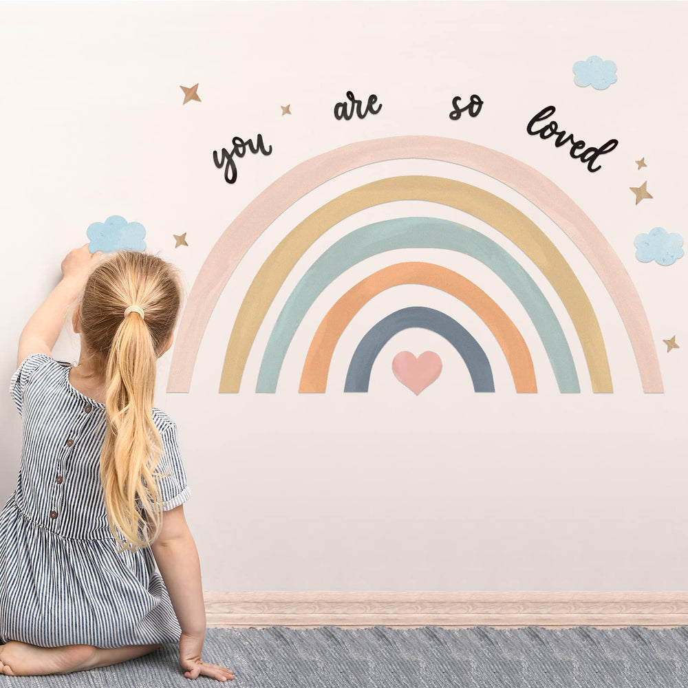 Containlol rainbow wall decal in a girl's bedroom creates warm ambience.