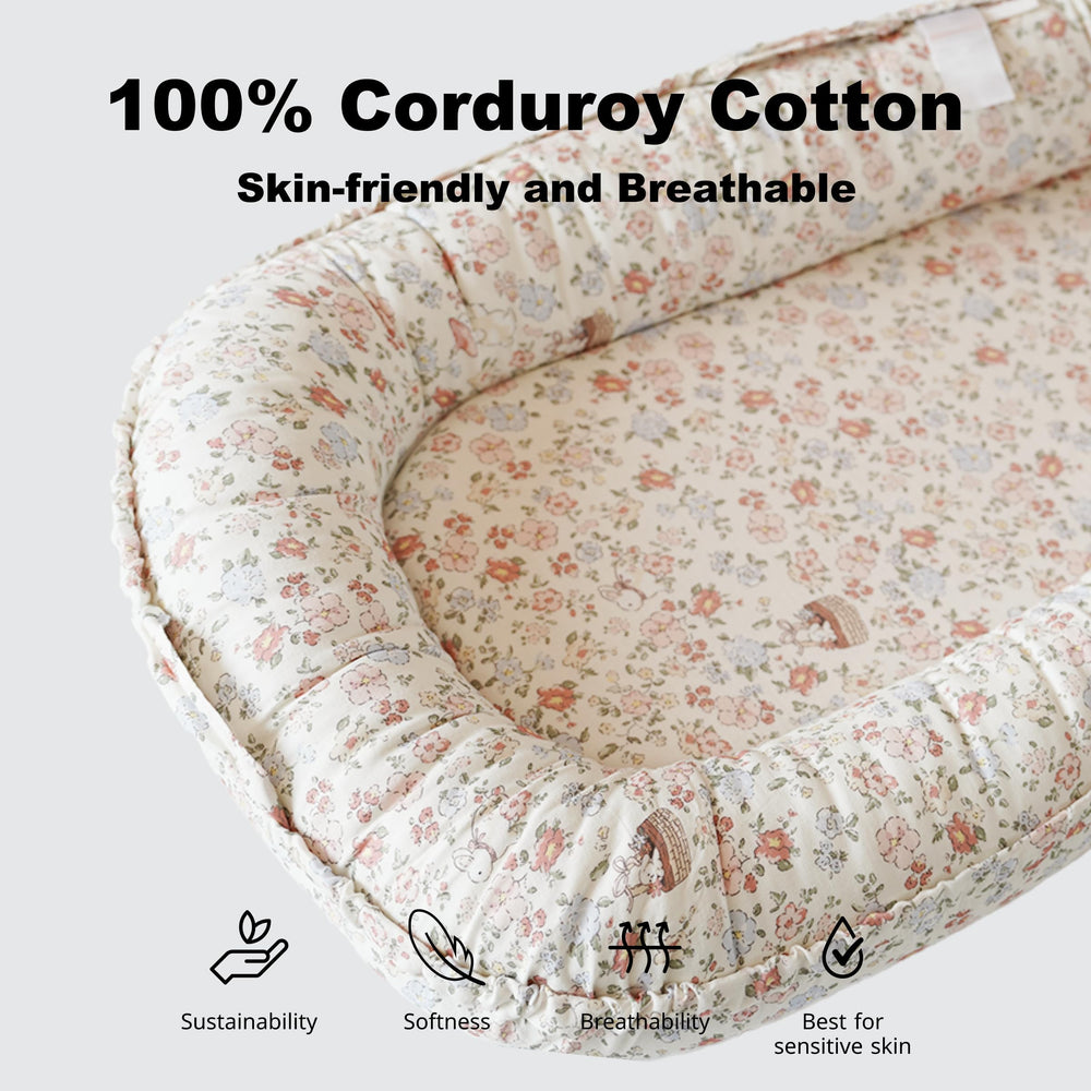 CooCooBaby lounger fabric closeup shows 100% cotton texture and soft skin-friendly feel.