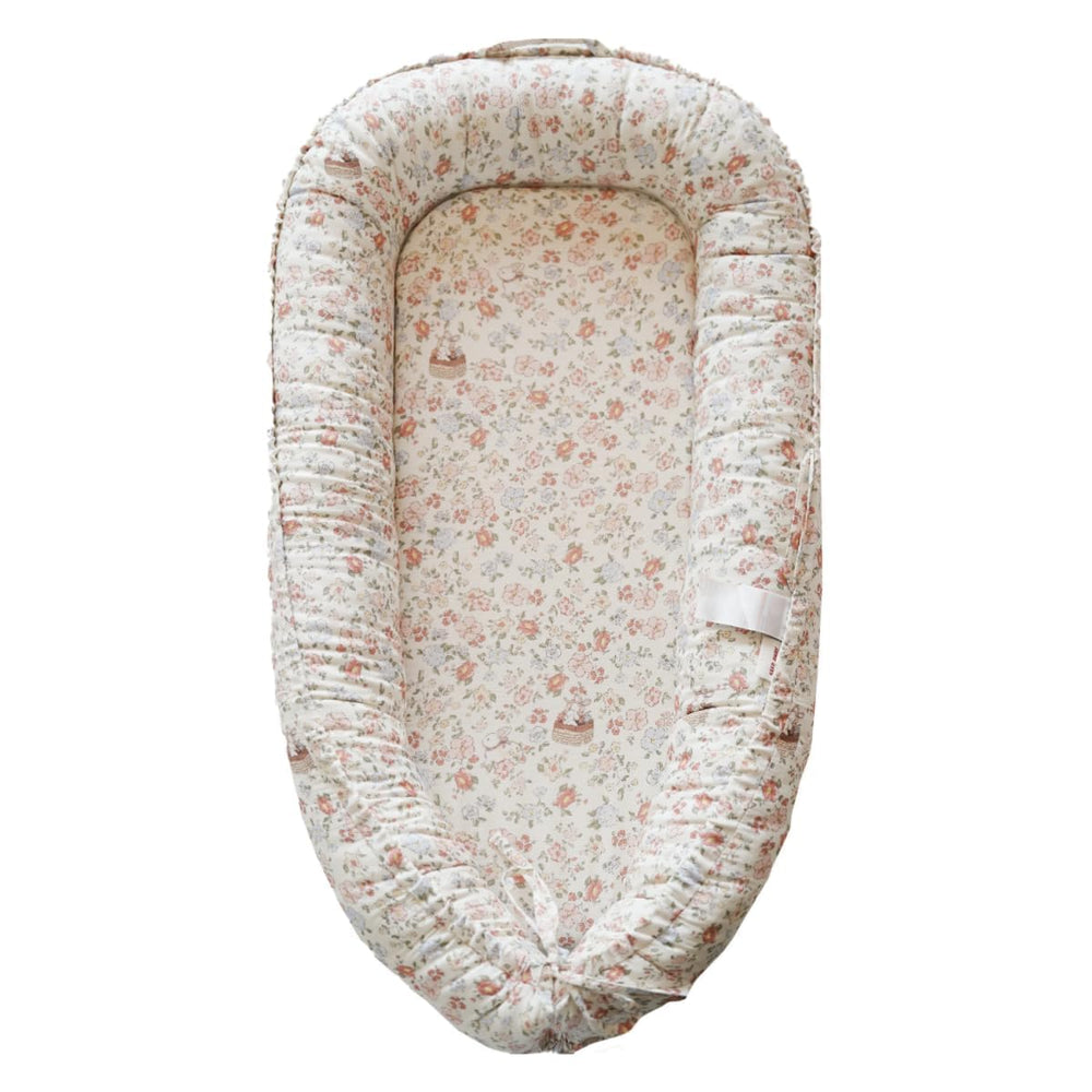 CooCooBaby infant lounger front view with Wonderland Muslin cover for gentle, breathable comfort.