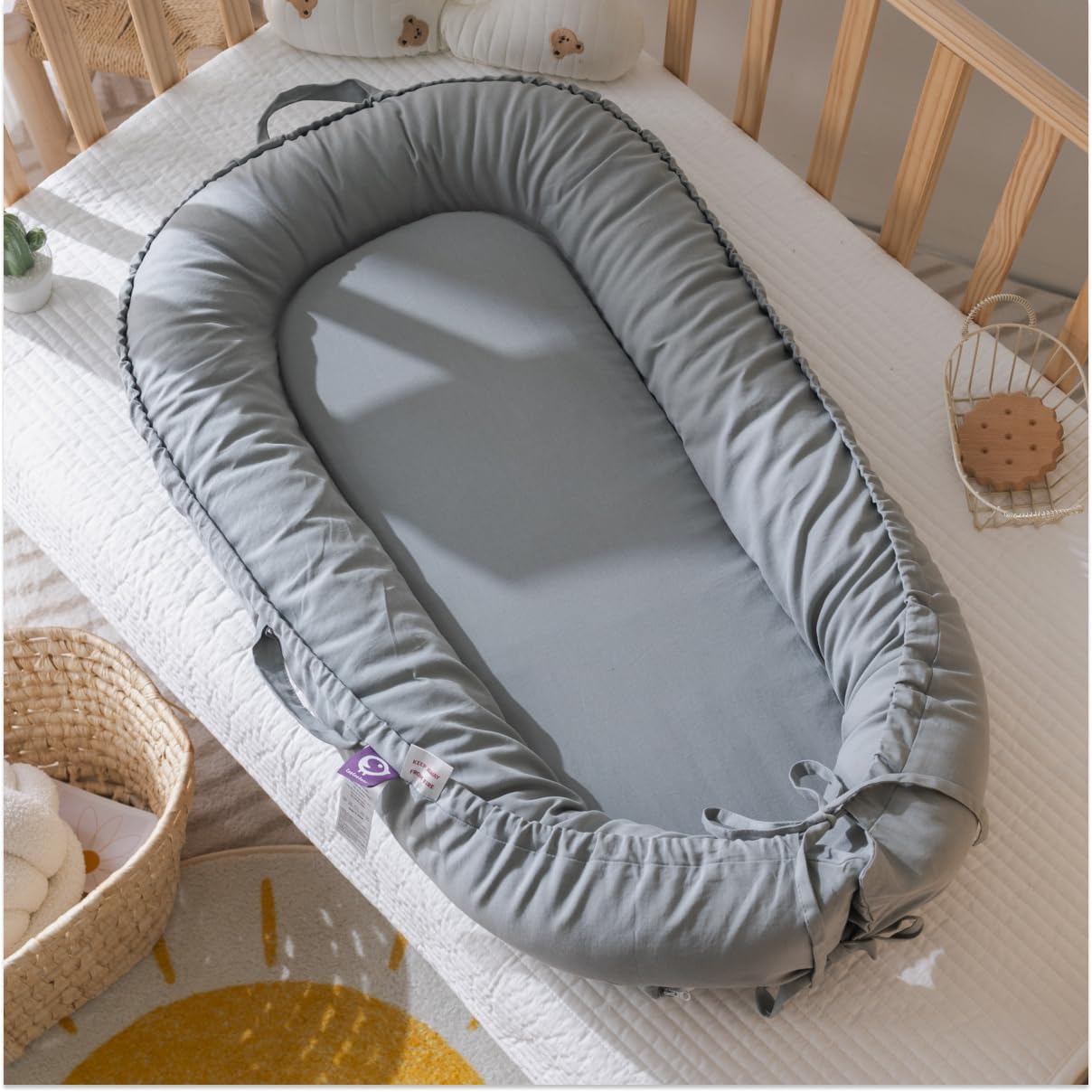 CooCooBaby lounger side view shows adaptable, secure design for growing babies