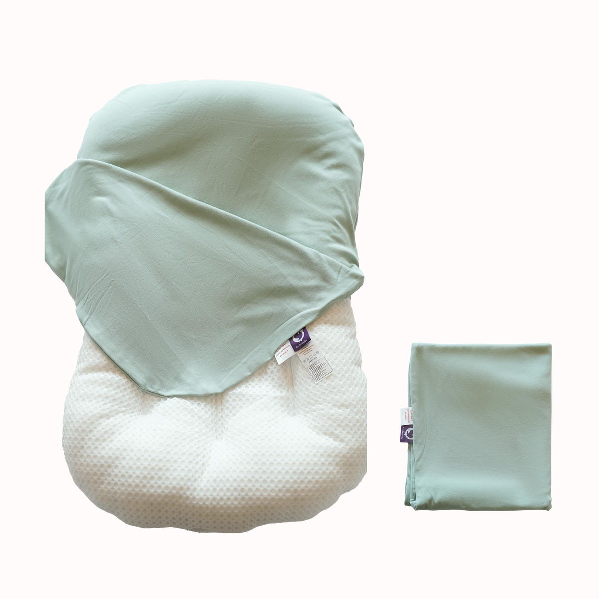 CooCooBaby sage green organic infant lounger cover cradling baby's skin.