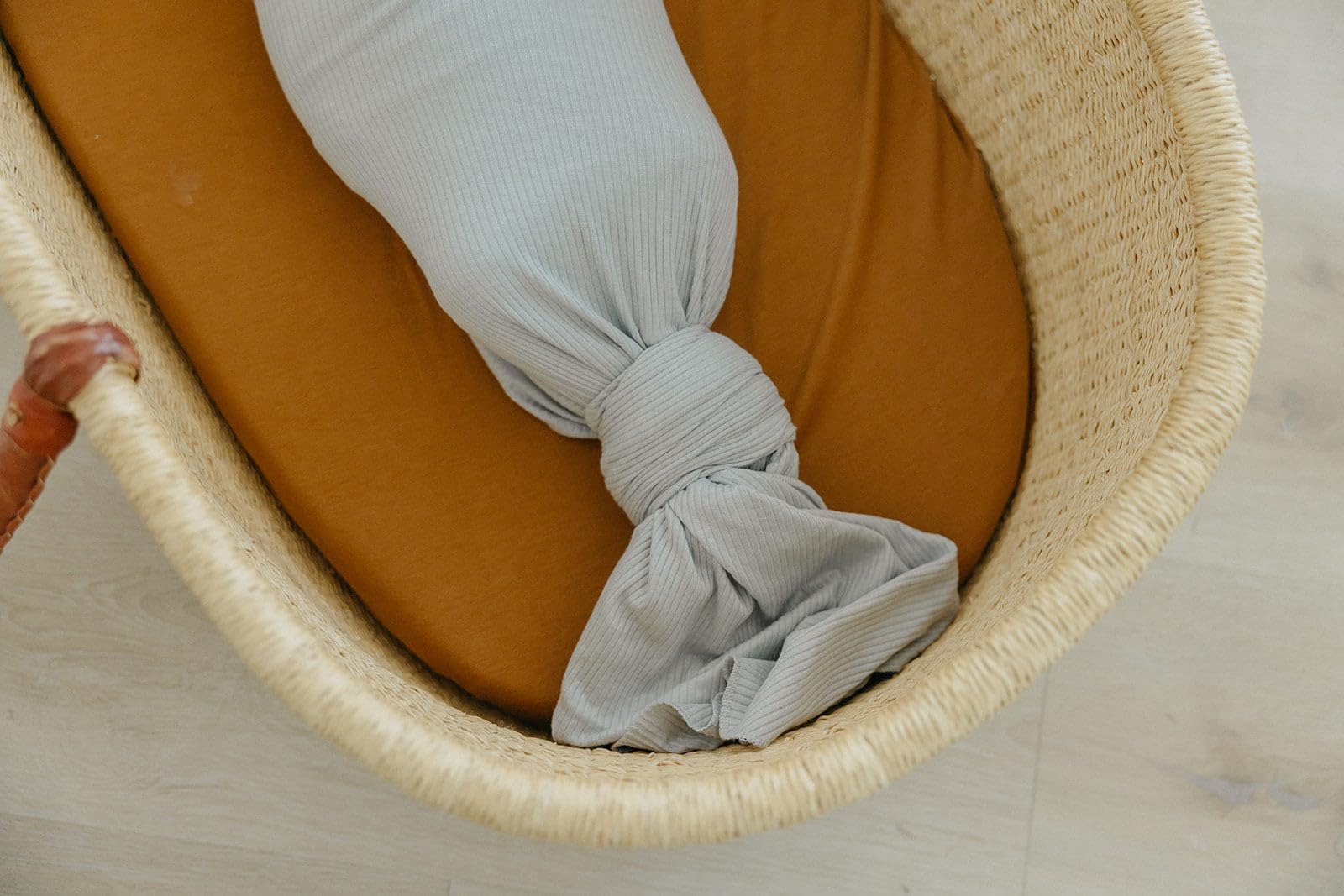 Copper Pearl Ash receiving blanket used as a cozy multipurpose wrap