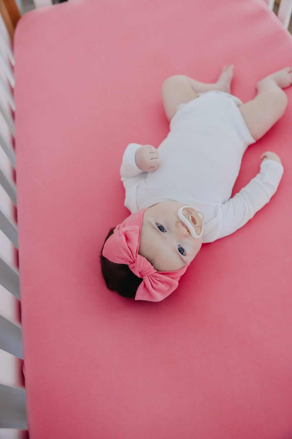 Copper Pearl baby bows coordinate with swaddles and covers for a cohesive look.