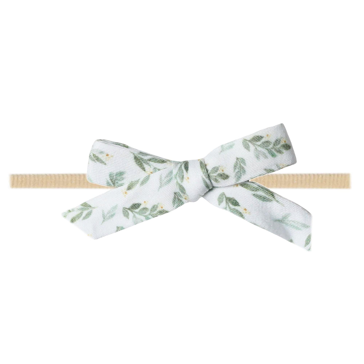 Copper Pearl floral polka dot baby bow on a soft stretch headband for newborn comfort.