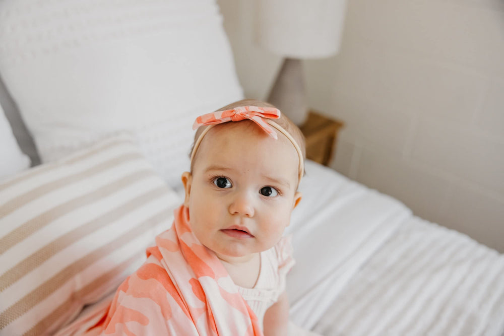 Copper Pearl Remi bow with gold accents, elevates any baby outfit