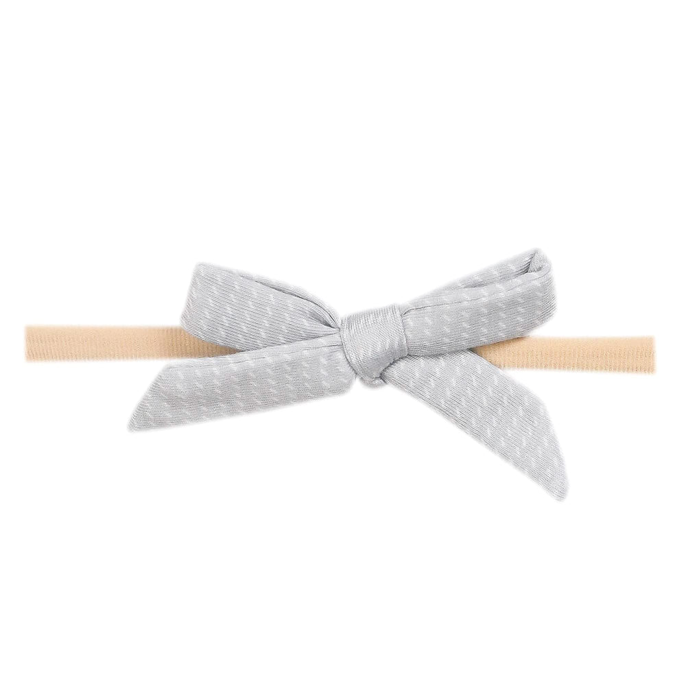 Copper Pearl baby bows on a soft newborn headband for gentle, comfortable wear