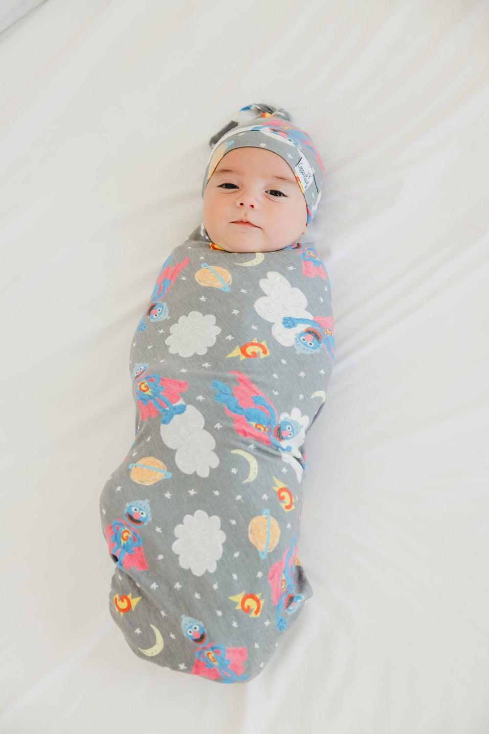 Copper Pearl baby using blanket as stroller shield during outdoor outings.