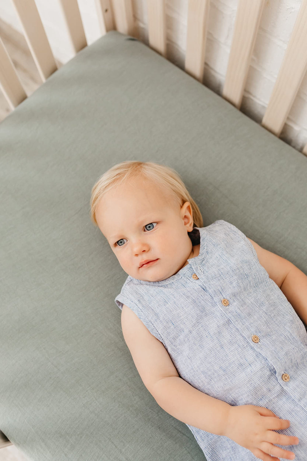 Copper Pearl Briar knit crib sheet edge close-up highlighting reinforced elastic