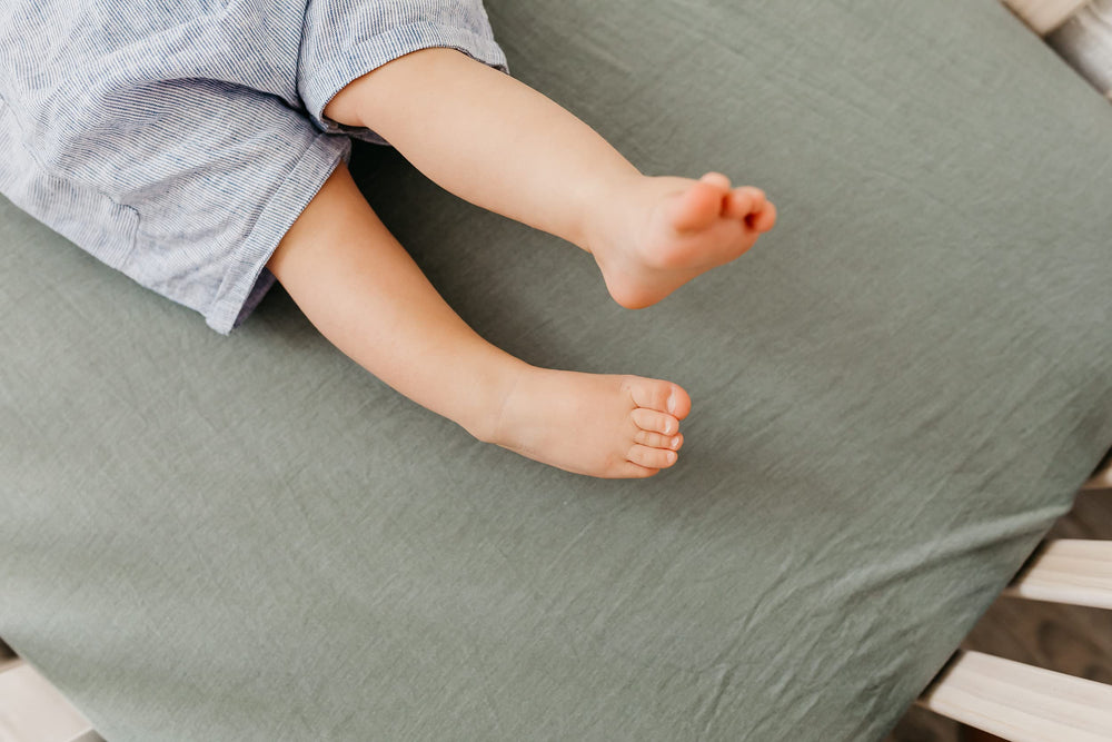 Copper Pearl Briar knit crib sheet with coordinating tones in a cozy nursery
