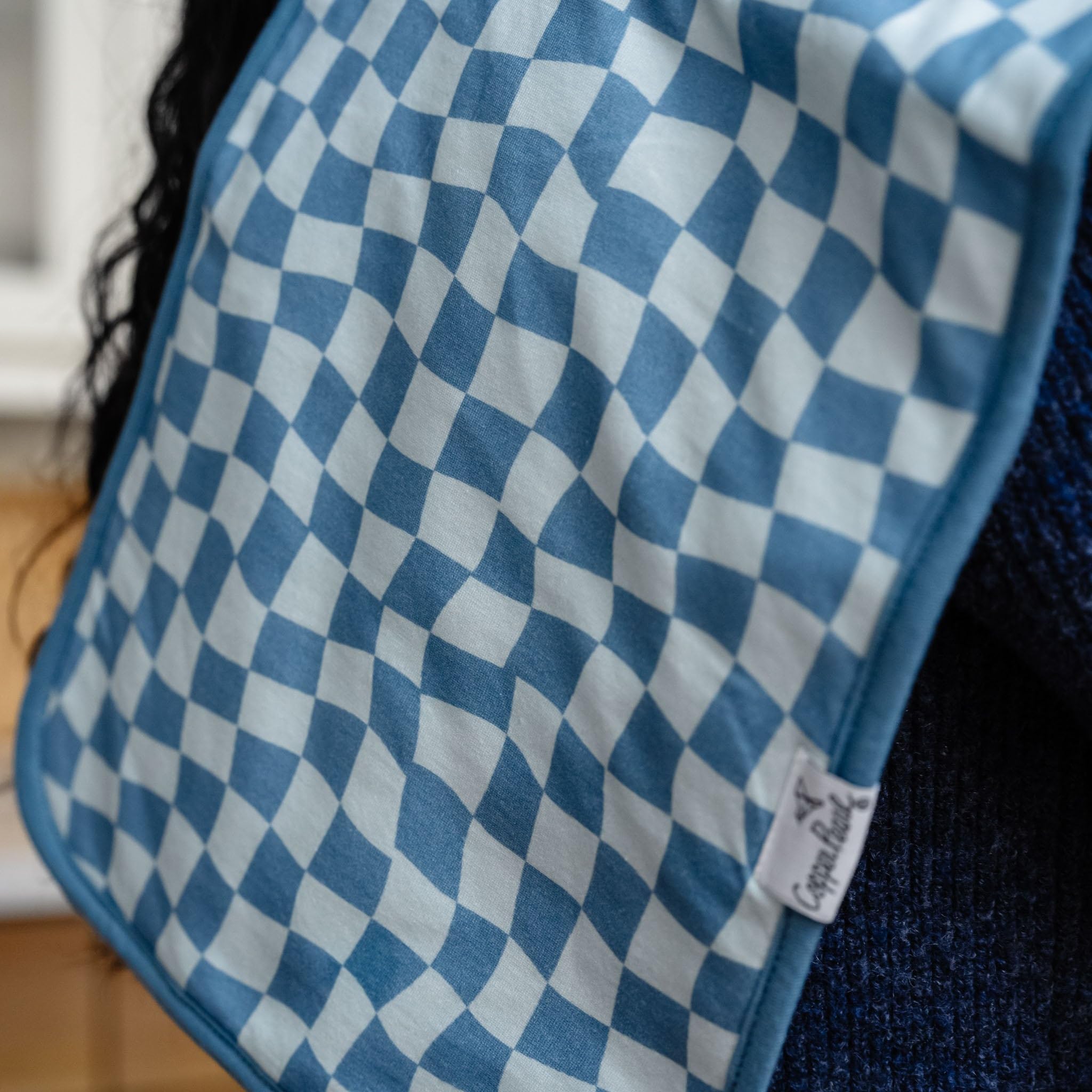 Copper Pearl oversized burp cloth protects outfits during feeding.
