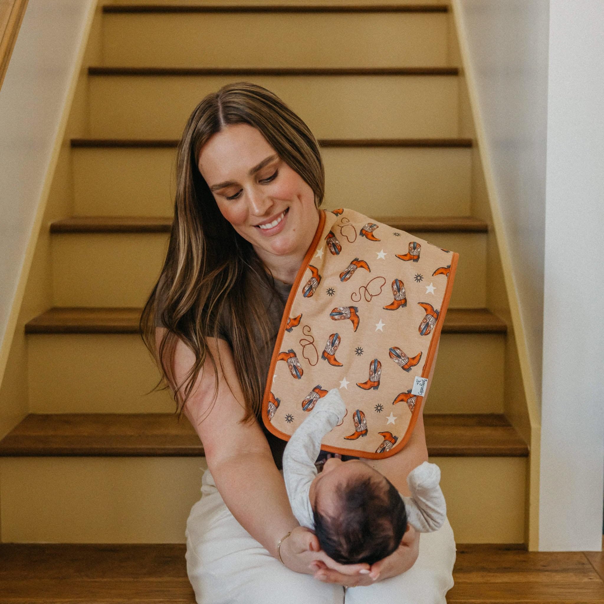 Copper Pearl burp cloth shown with matching bandana bibs for coordinated styling