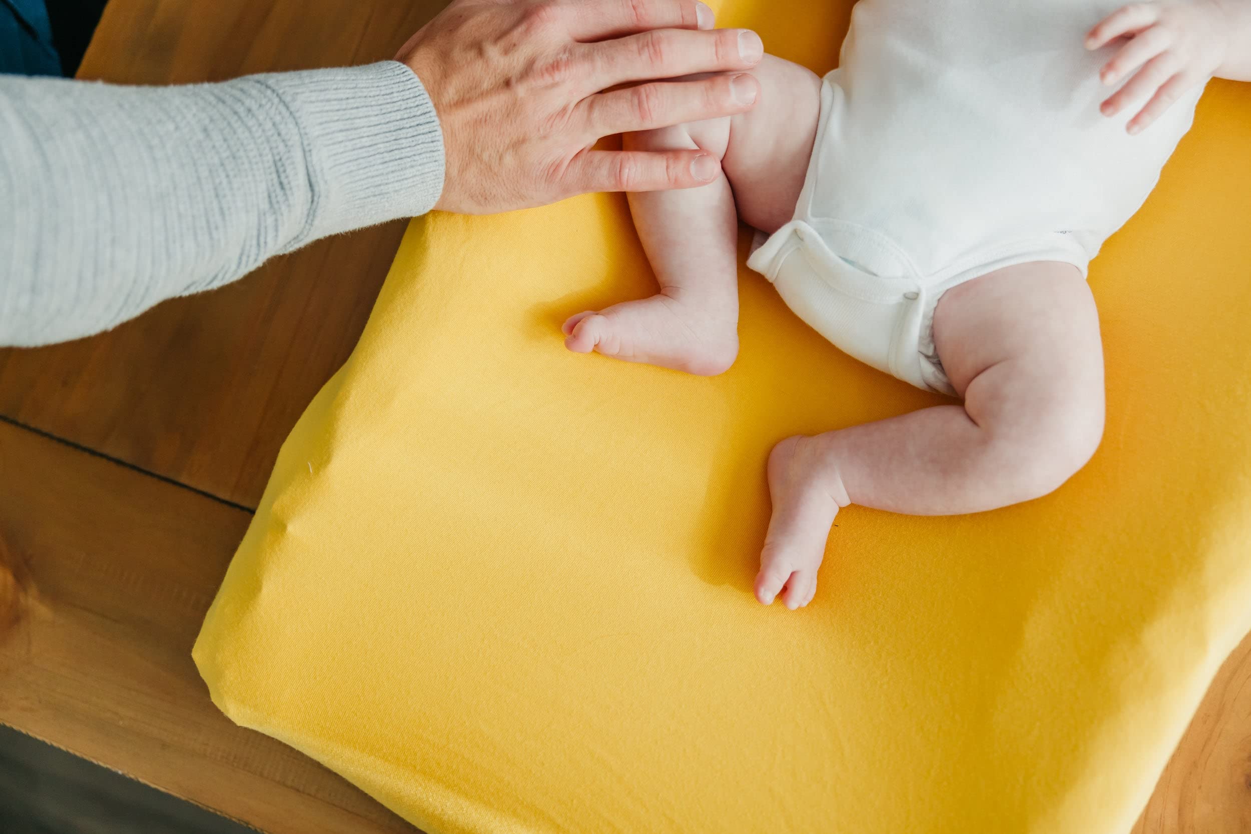 Copper Pearl banana changing pad cover soft-touch fabric in cozy nursery setting