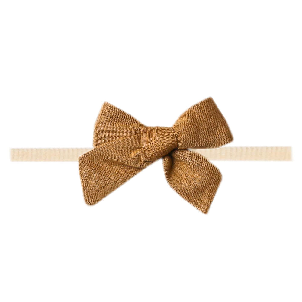 Copper Pearl Classic Baby Bow Camel close-up shows plush fabric and bow detail for soft comfort