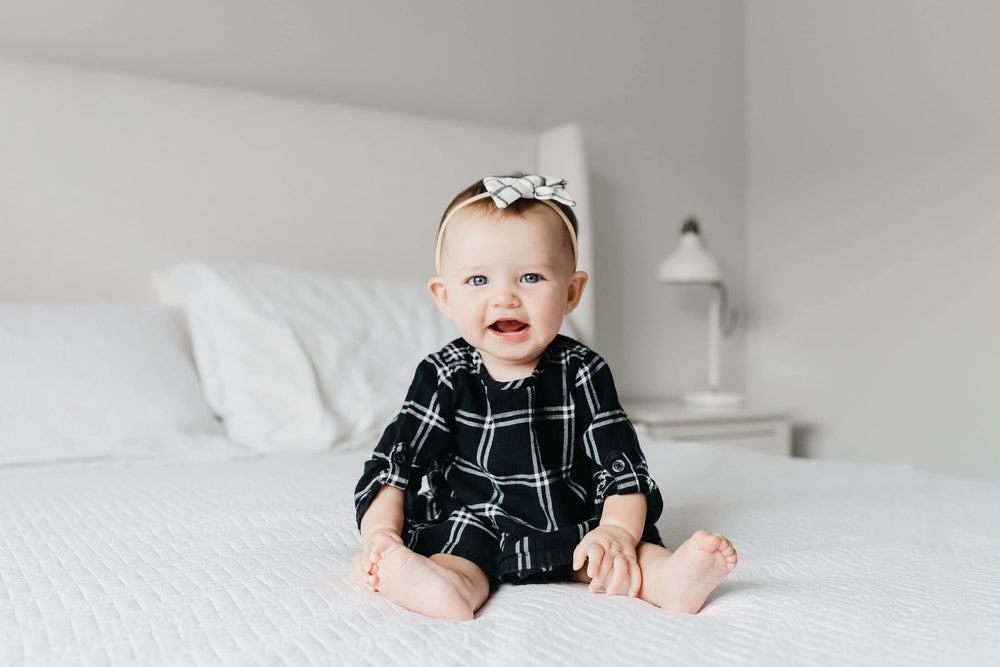 Copper Pearl Classic Baby Bow Ledger worn on newborn demonstrates gentle stretch