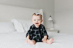 Copper Pearl Classic Baby Bow Ledger worn on newborn demonstrates gentle stretch