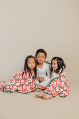 Copper Pearl Claus jumbo knit blanket on couch during family relaxation
