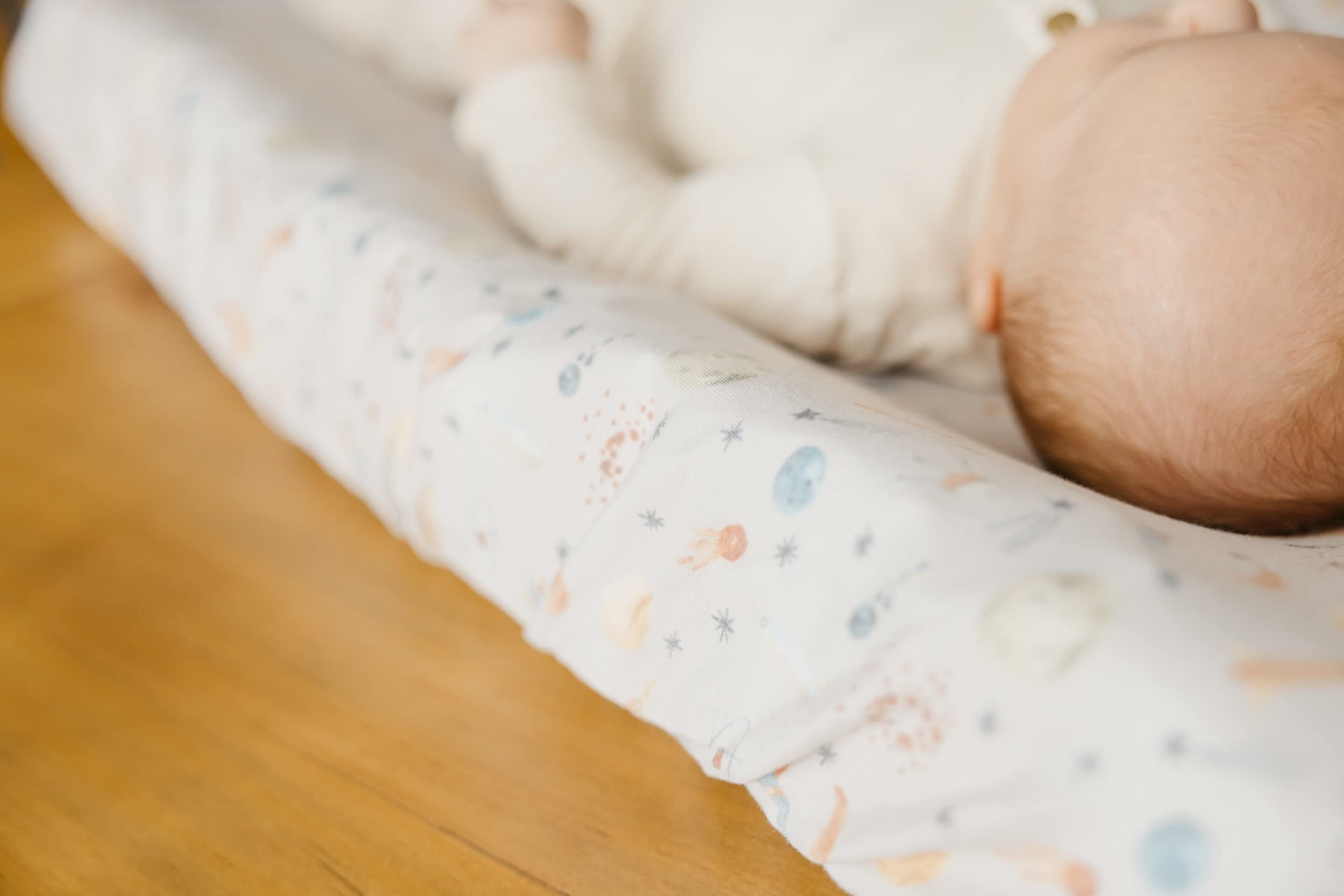 Copper Pearl Cosmos cover on changing table during baby change