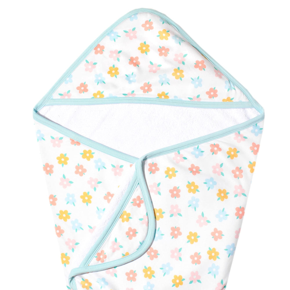 Copper Pearl Daisy hooded bath towel keeps baby warm after bath.