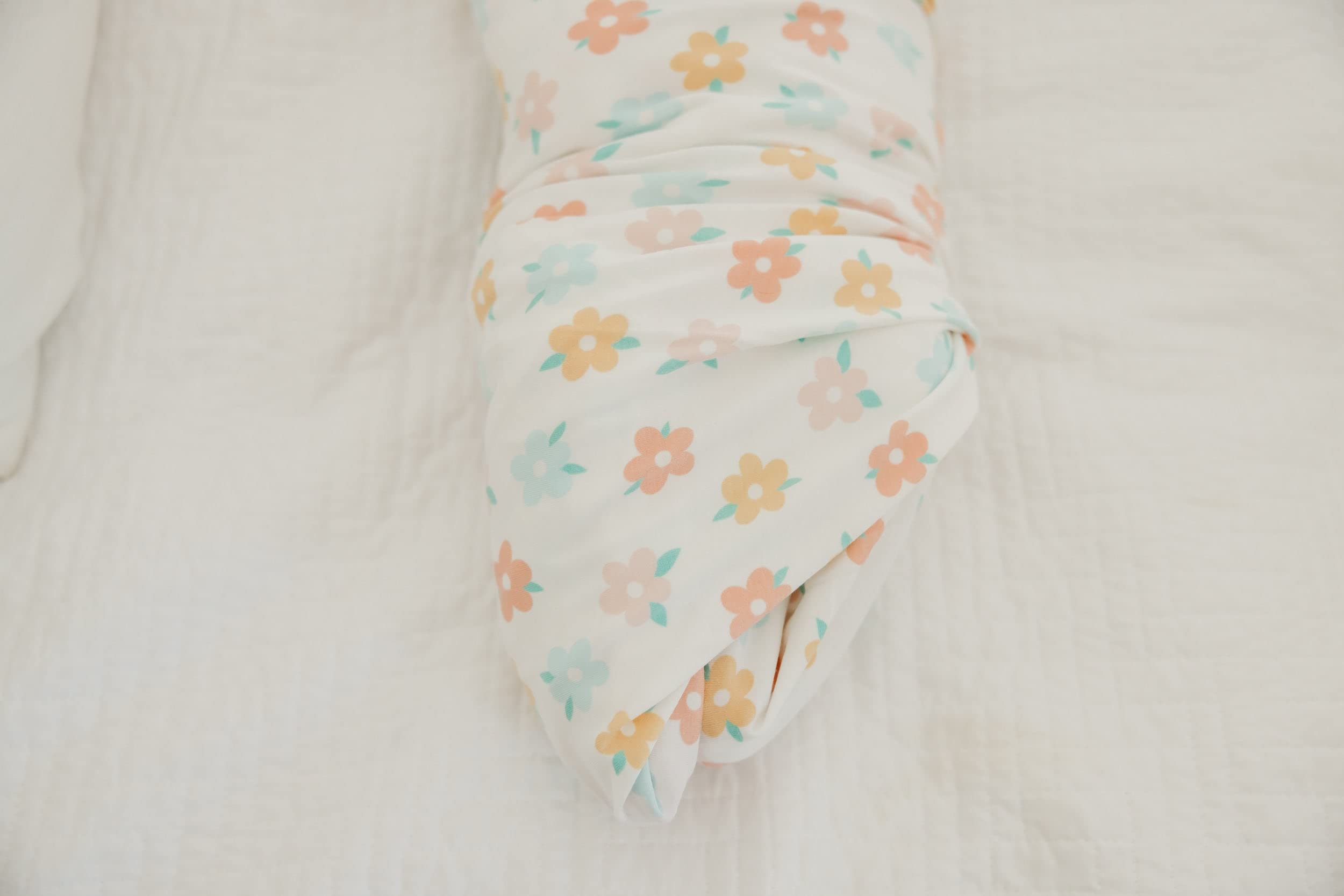 Copper Pearl Daisy swaddle blanket worn as baby wrap during cuddles.