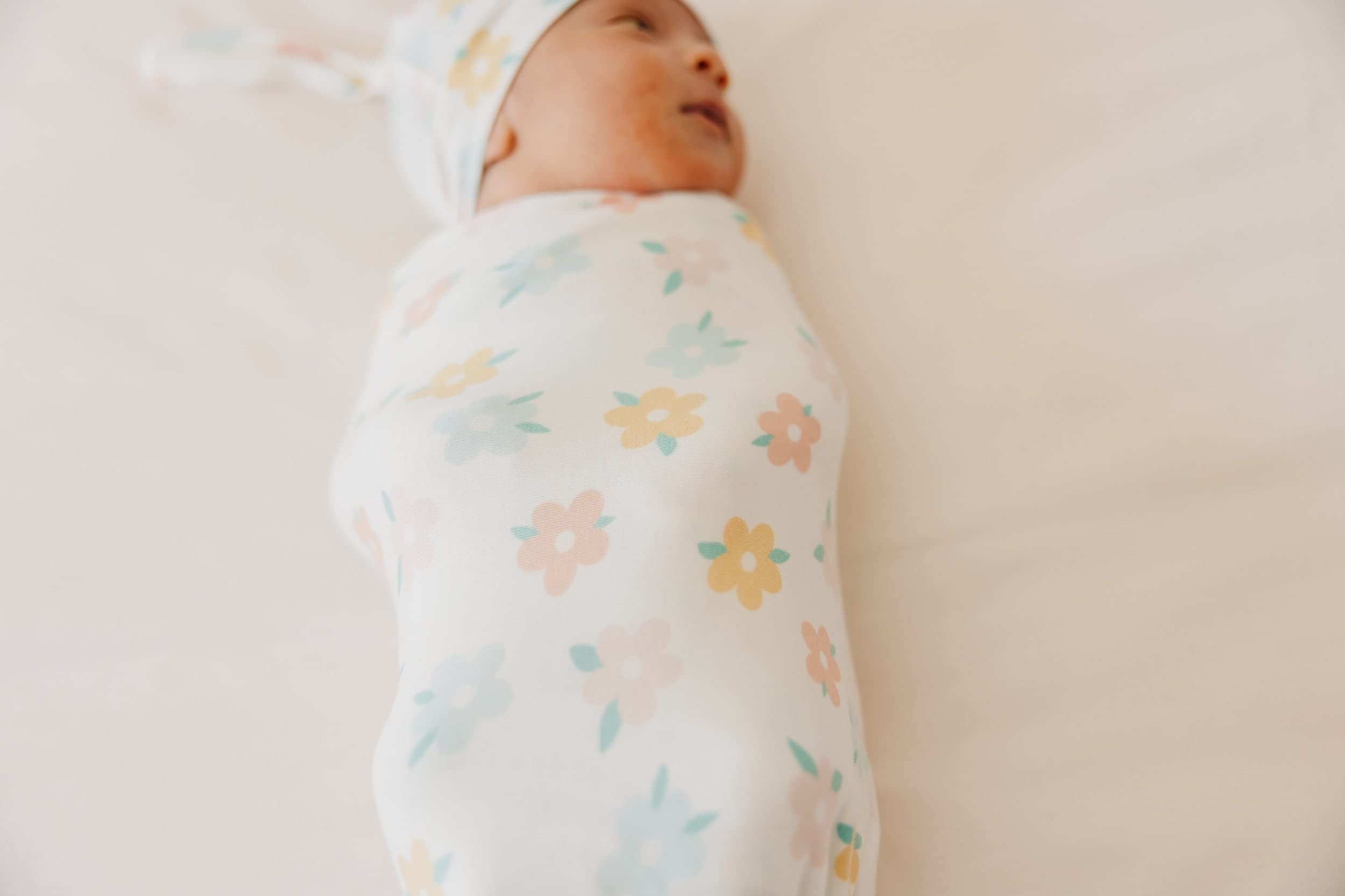 Copper Pearl Daisy swaddle blanket draped as stroller shield on outings.