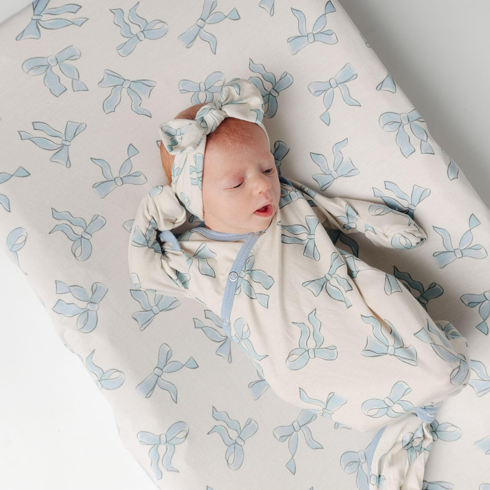 Copper Pearl Daphne universal-fit cover with elastic edge on a changing pad