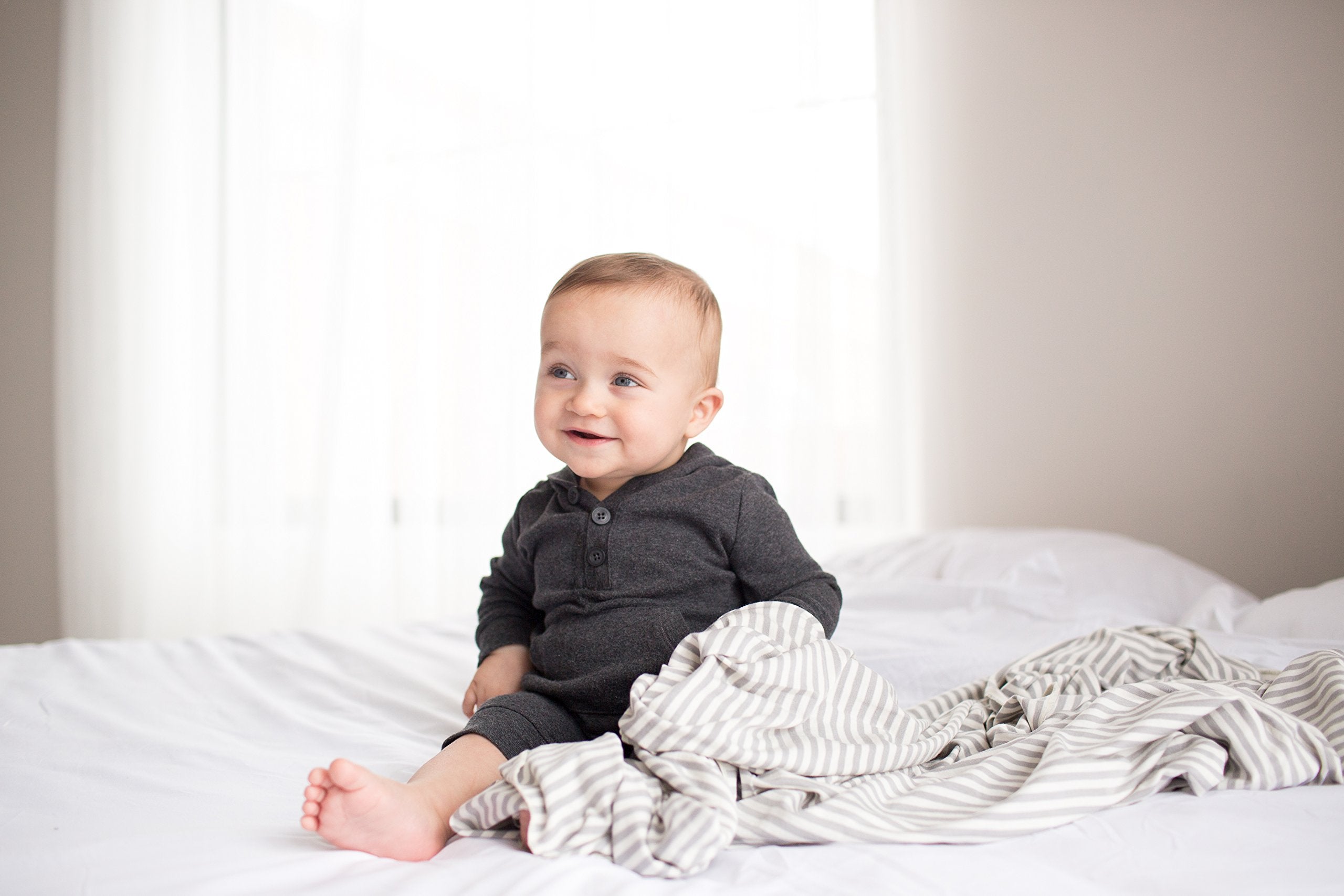 Baby wrapped in Copper Pearl Everest swaddle during nap time