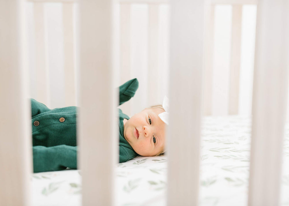 Soft scene of Copper Pearl fern knit crib sheet in a cozy crib for restful sleep