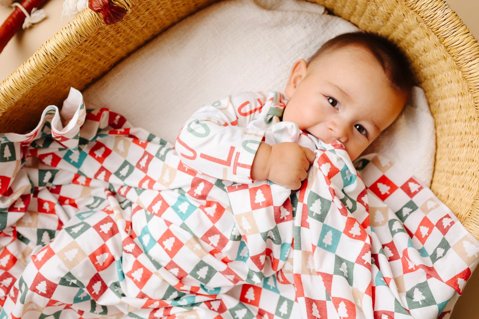 Copper Pearl Fraser swaddle blanket beside a sleeping baby.