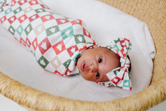 Copper Pearl Fraser swaddle blanket on baby, offering cozy, secure wrap.