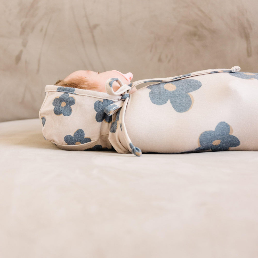 Copper Pearl Gemma Tan swaddle blanket folded for compact storage and travel convenience
