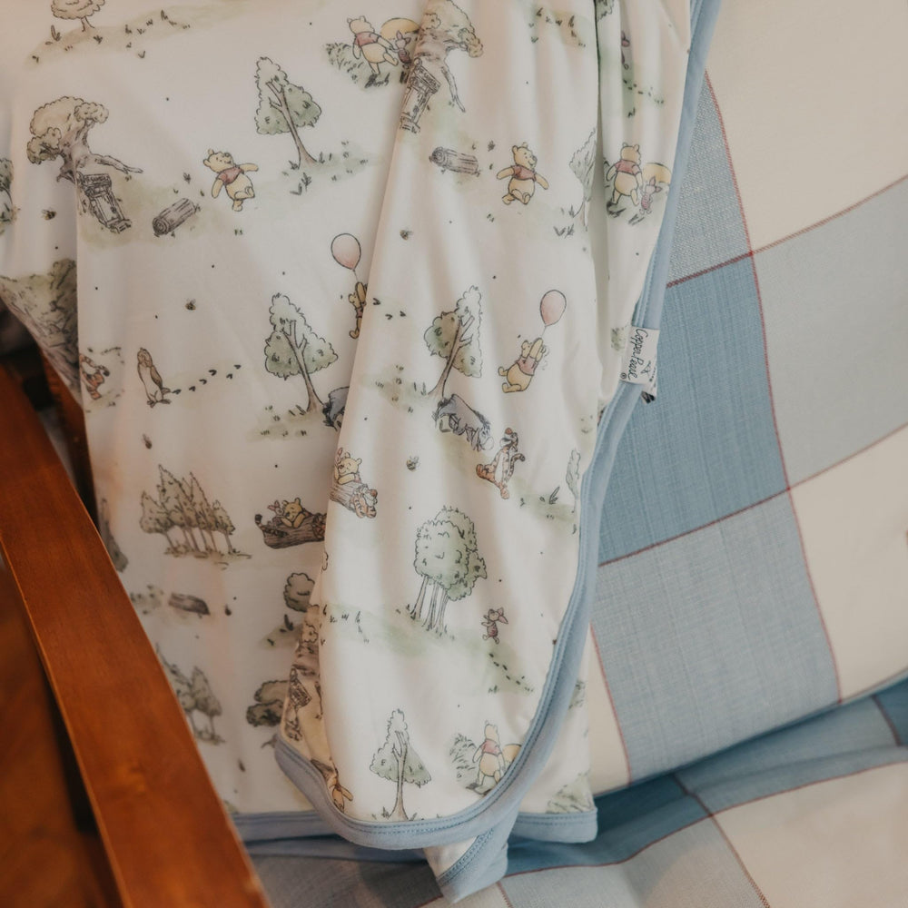 Copper Pearl Hundred Acre Wood quilt folded, ready for nursery storage or gifting