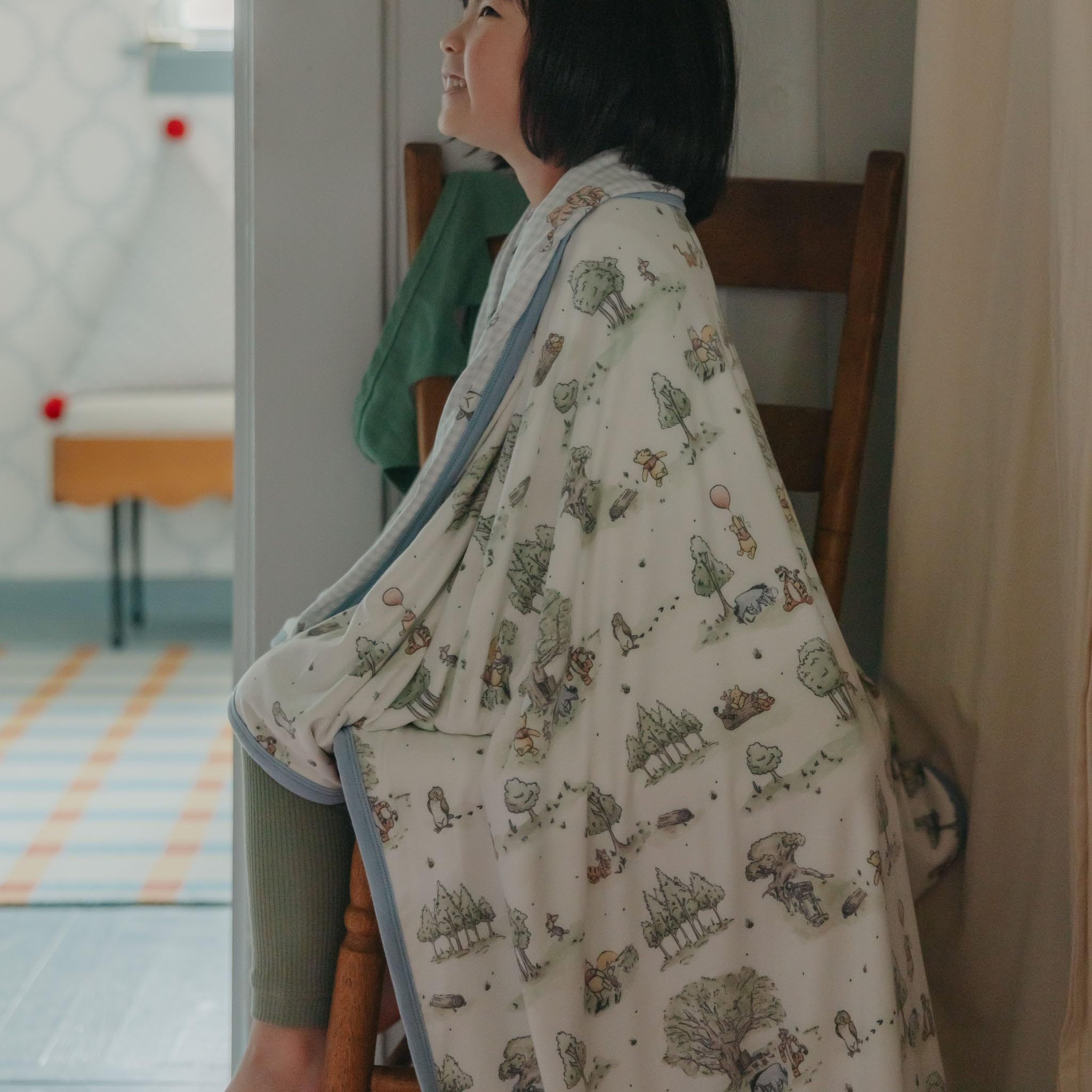 Copper Pearl Hundred Acre Wood quilt swaddle-style setup for calm cuddles