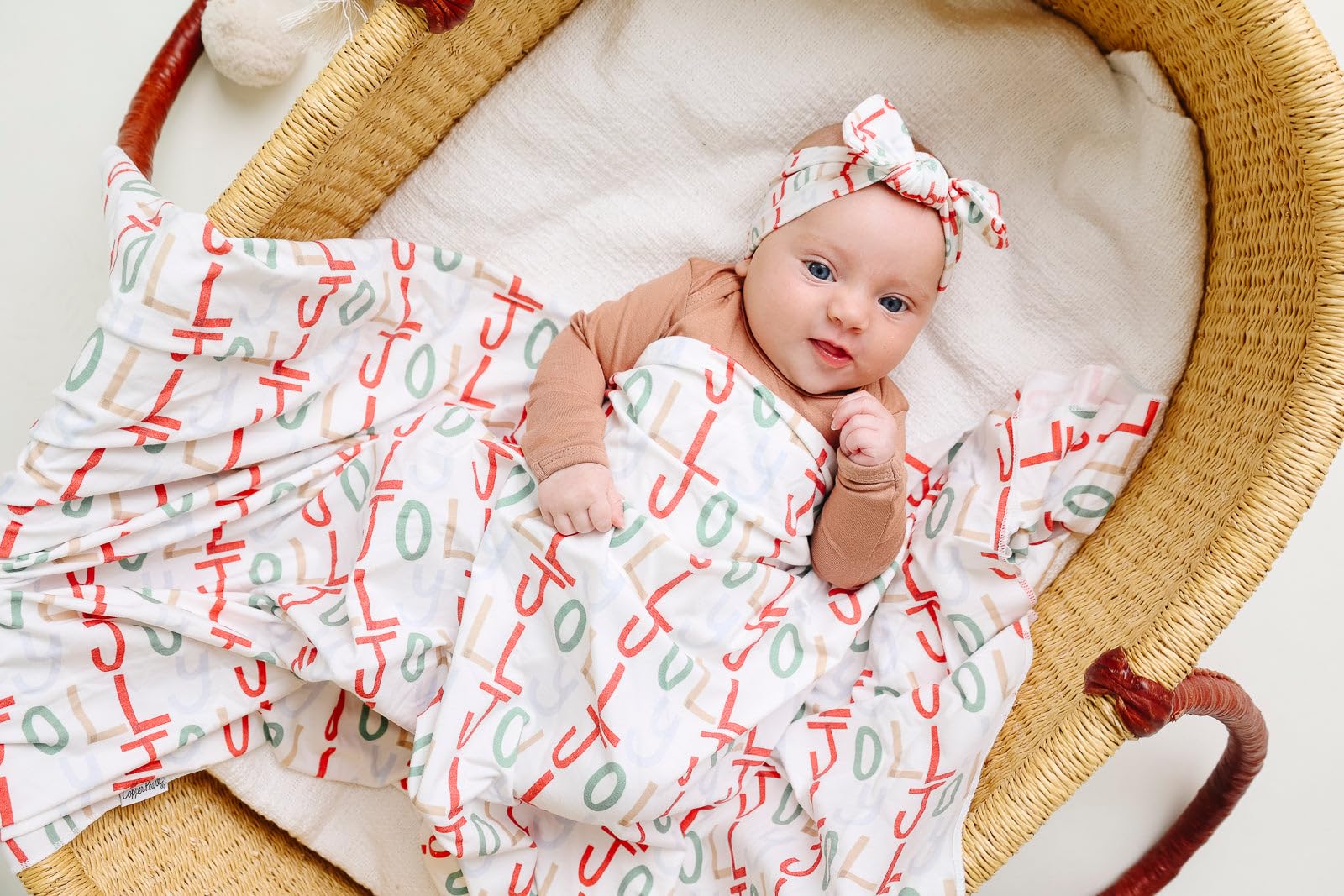 Copper Pearl Jolly swaddle demonstrates versatile newborn wrapping and easy blanket use