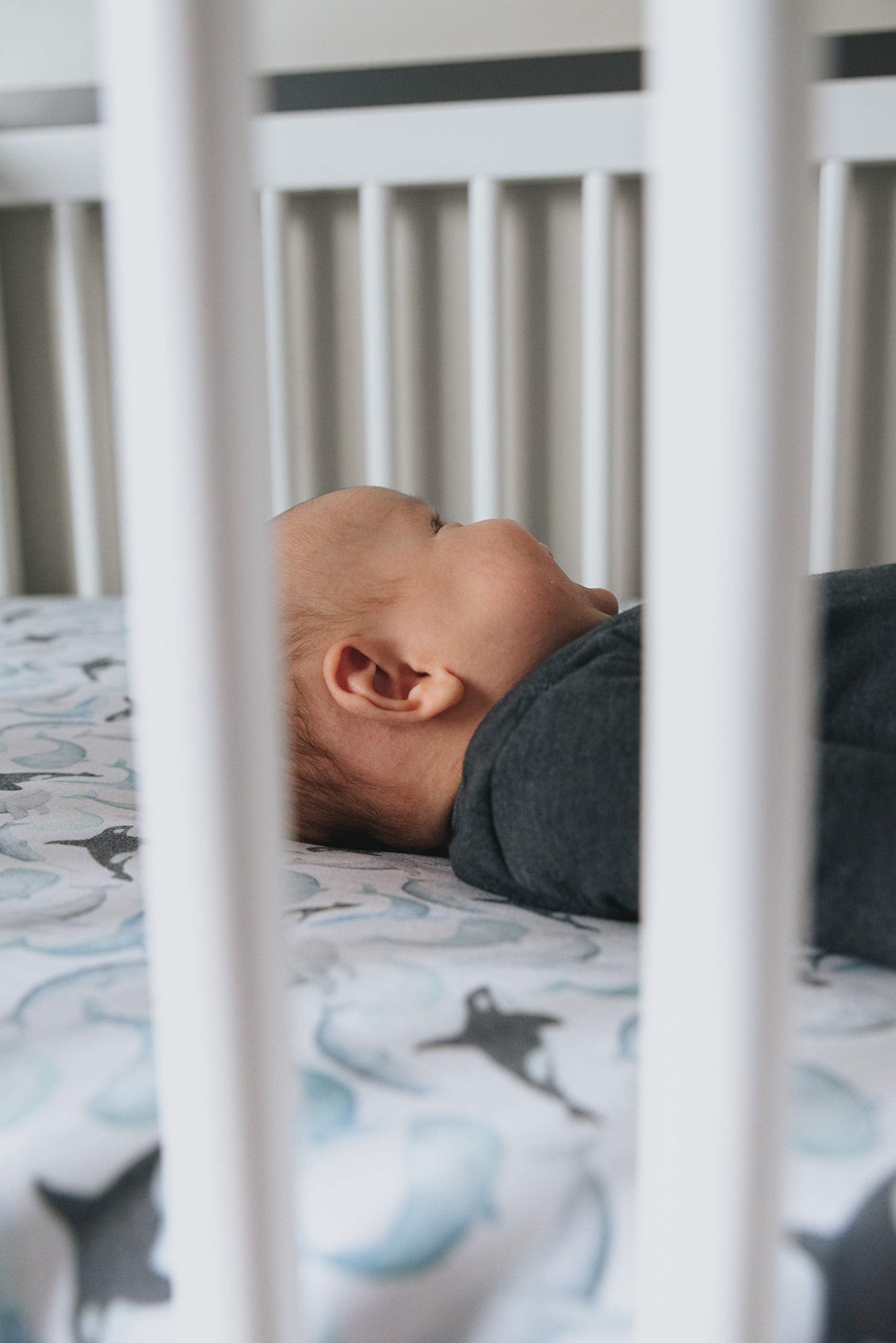 Copper Pearl Kai crib sheet on standard mattress ensuring baby comfort and safety.