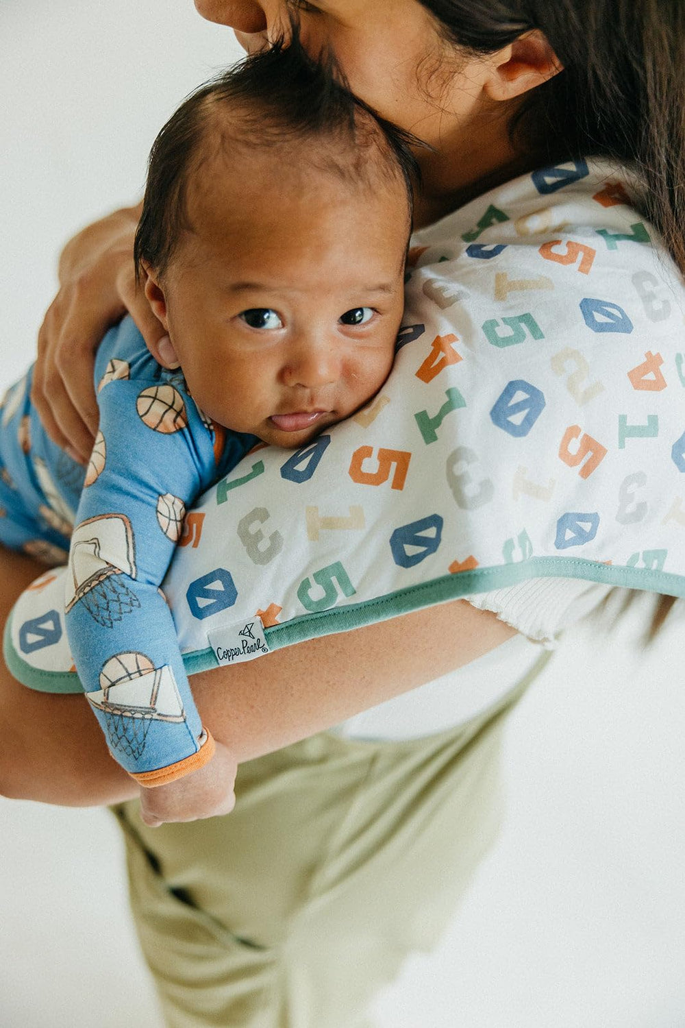 Copper Pearl large burp cloths provide extra shoulder coverage for mess-prone feedings.
