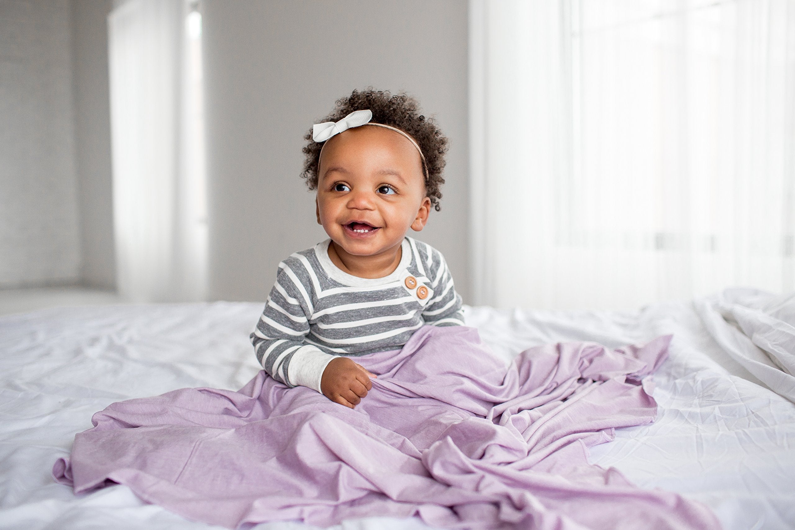 Copper Pearl Lily swaddle wrap doubles as a receiving blanket for growing babies.