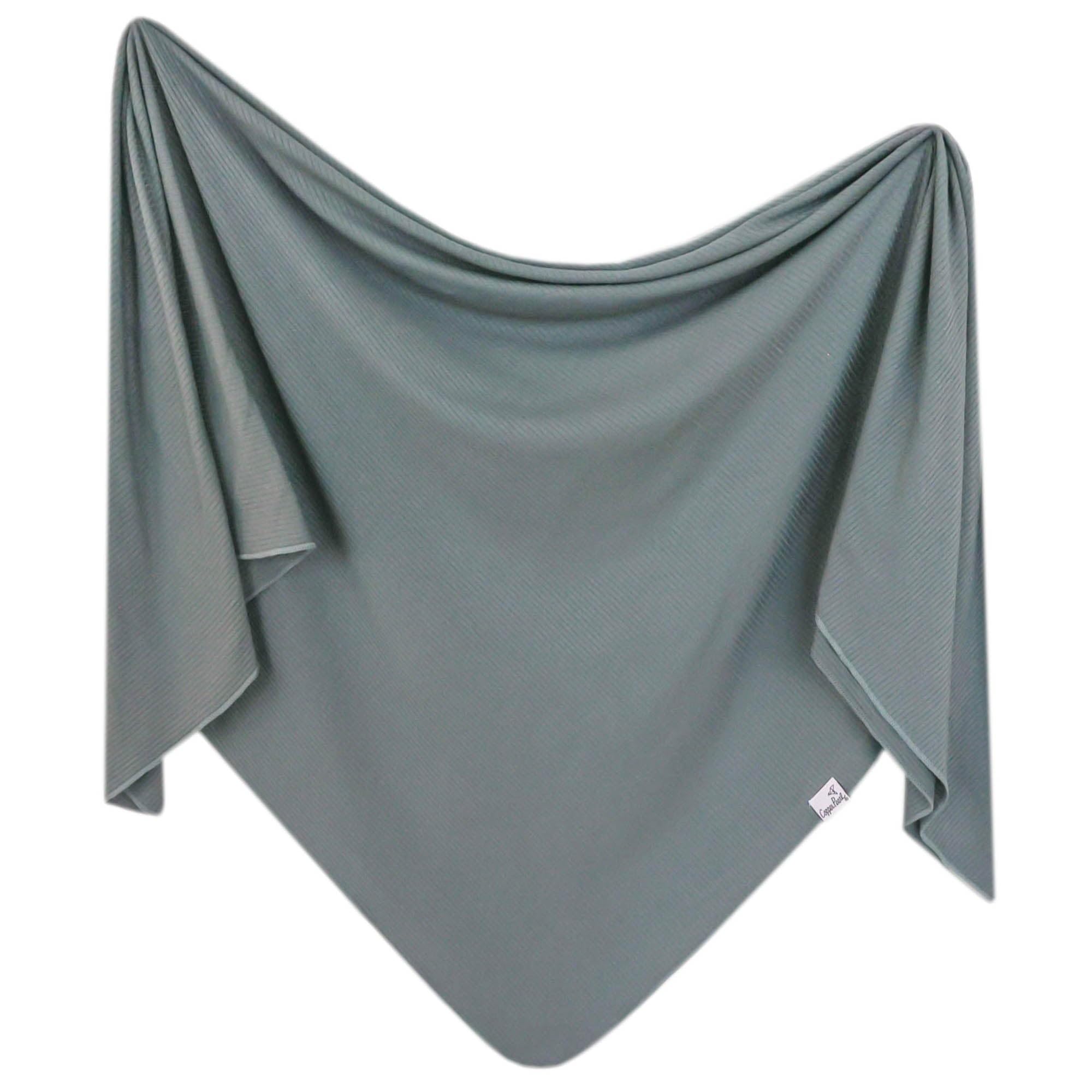 Copper Pearl Moss swaddle blanket close-up shows soft knit and breathable fabric for year-round comfort.