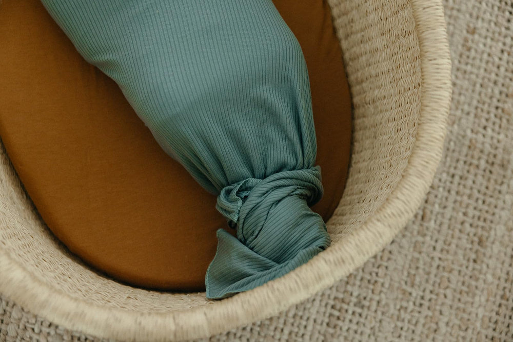 Copper Pearl Moss swaddle blanket provides stroller shield against sun and wind.