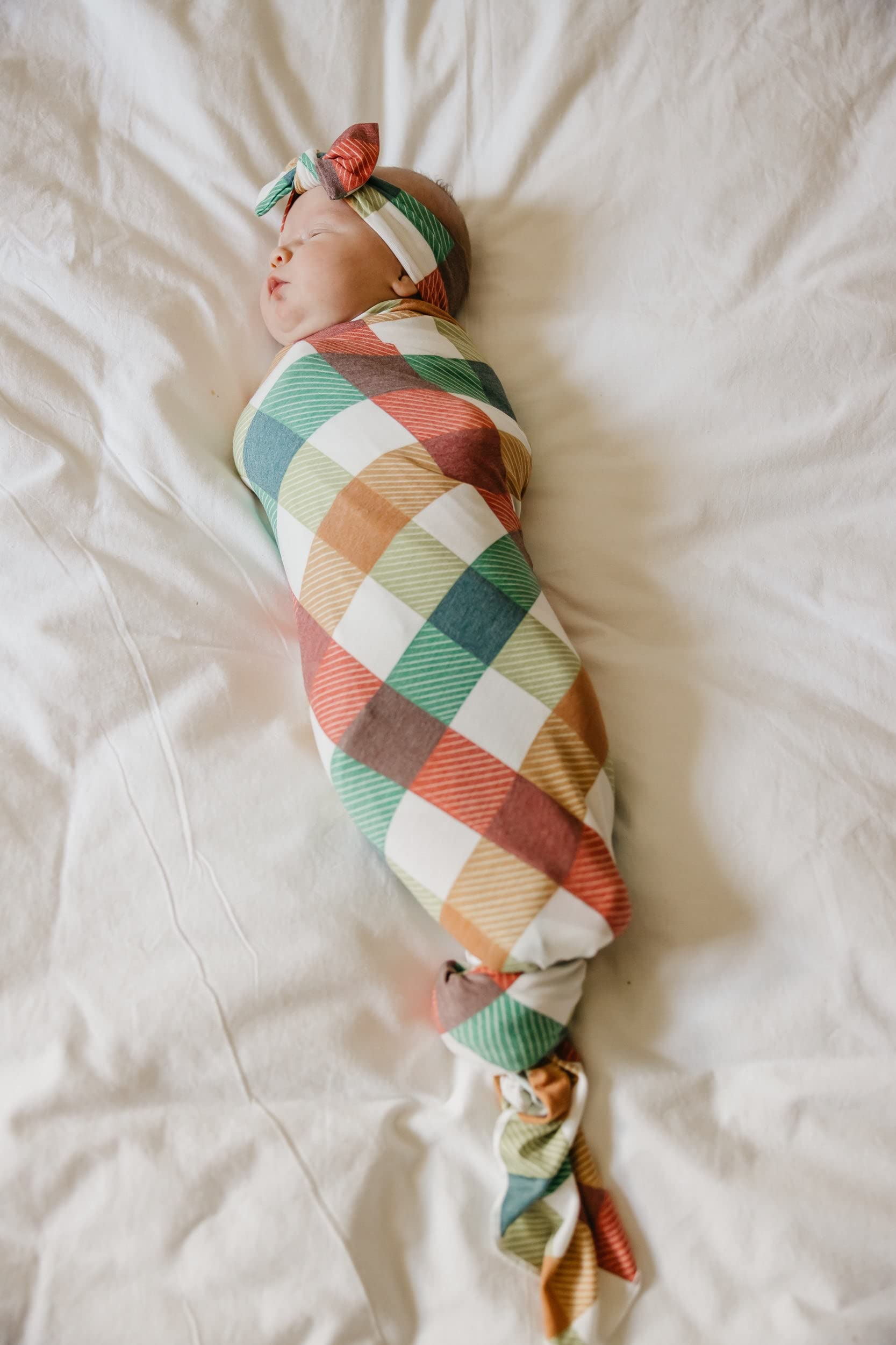 Copper Pearl Nicholas swaddle in use, snug and breathable for soothing newborn moments