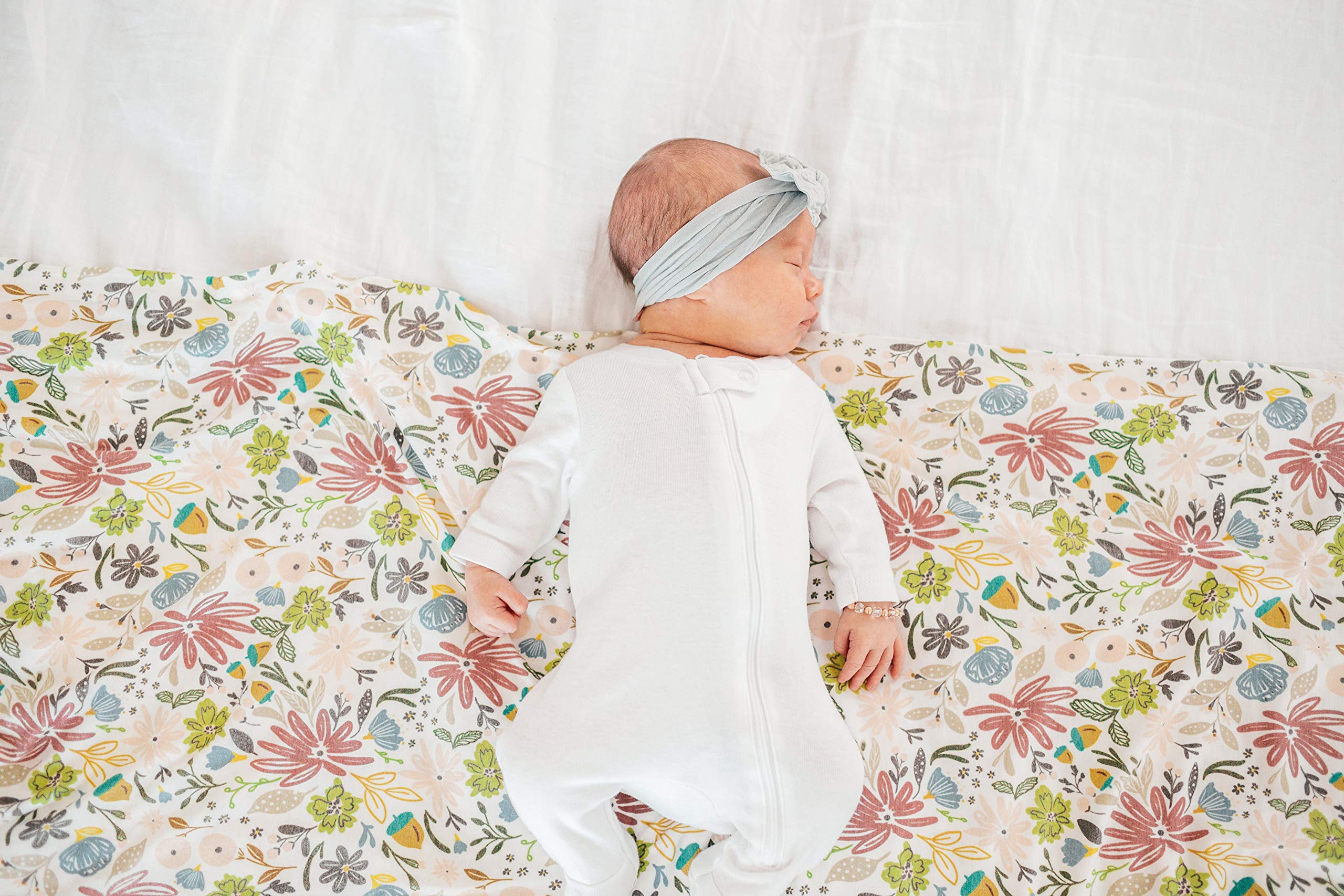 Copper Pearl olive baby resting on blanket, cozy nap-time companion.