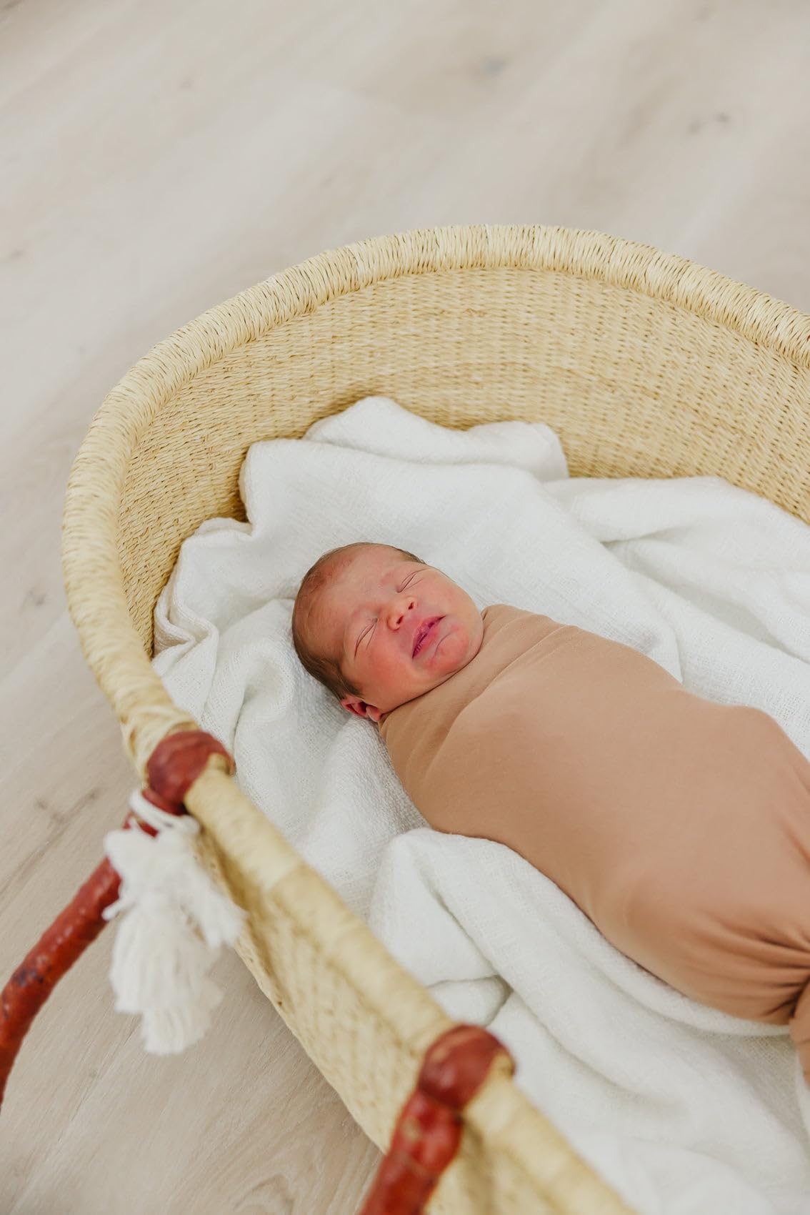 Copper Pearl pecan swaddle blanket features soft knit texture for breathable warmth.