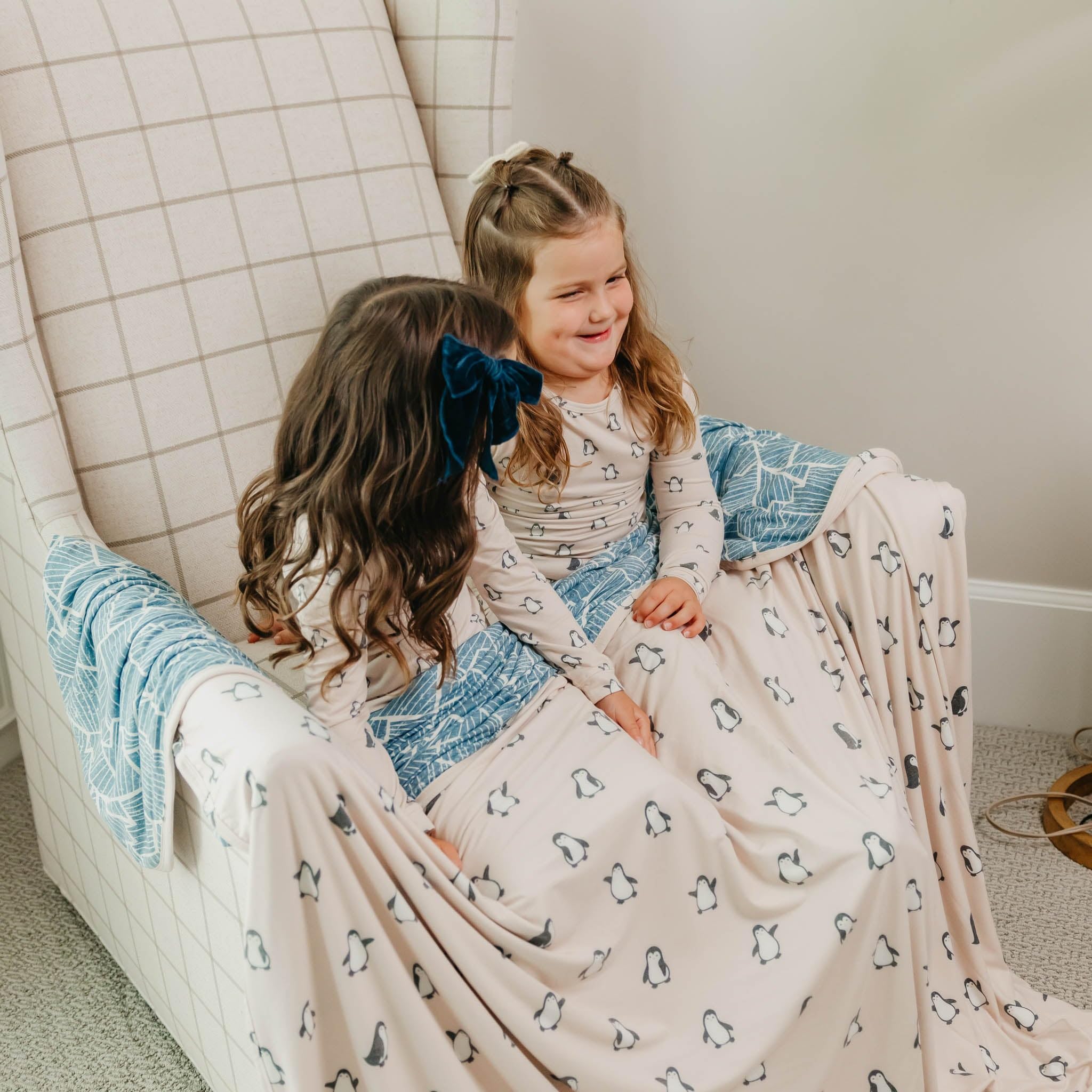 Copper Pearl Penguins Jumbo Quilt 60x72 on couch for family movie night