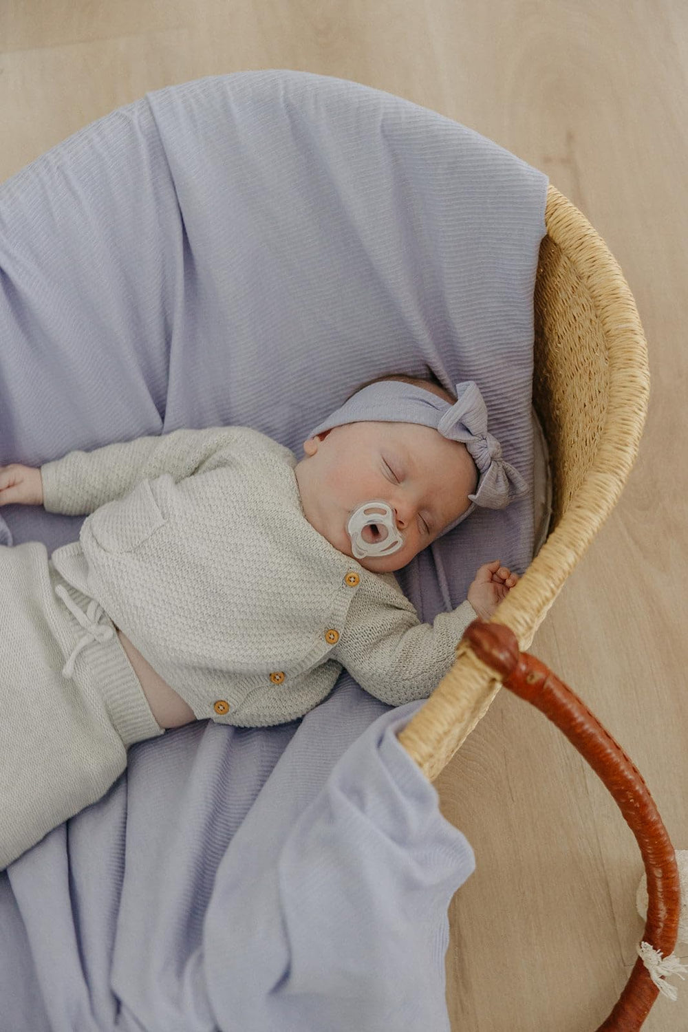 Copper Pearl Periwinkle swaddle draped on a crib for nursery comfort