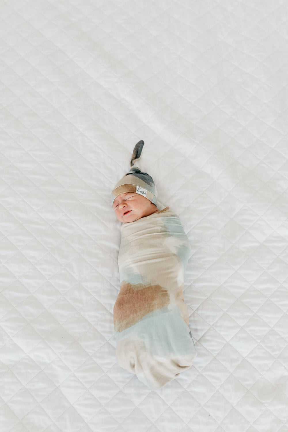 Copper Pearl Picasso large swaddle blanket folded neatly for gifting
