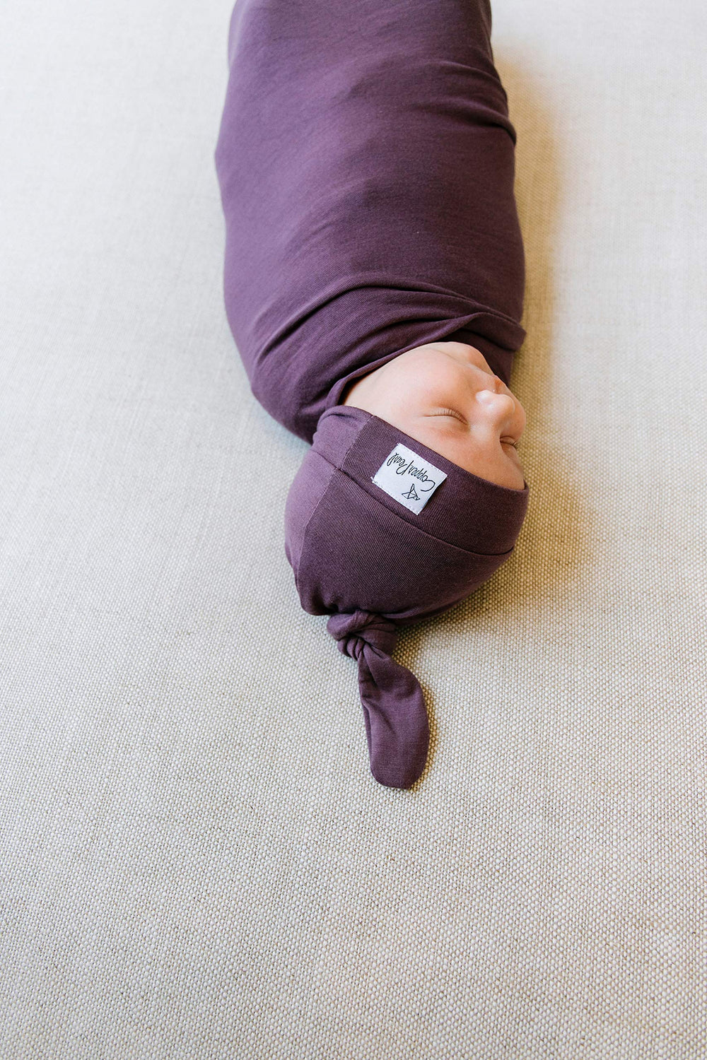 Copper Pearl plum swaddle blanket coordinates with outfits via stylish prints.