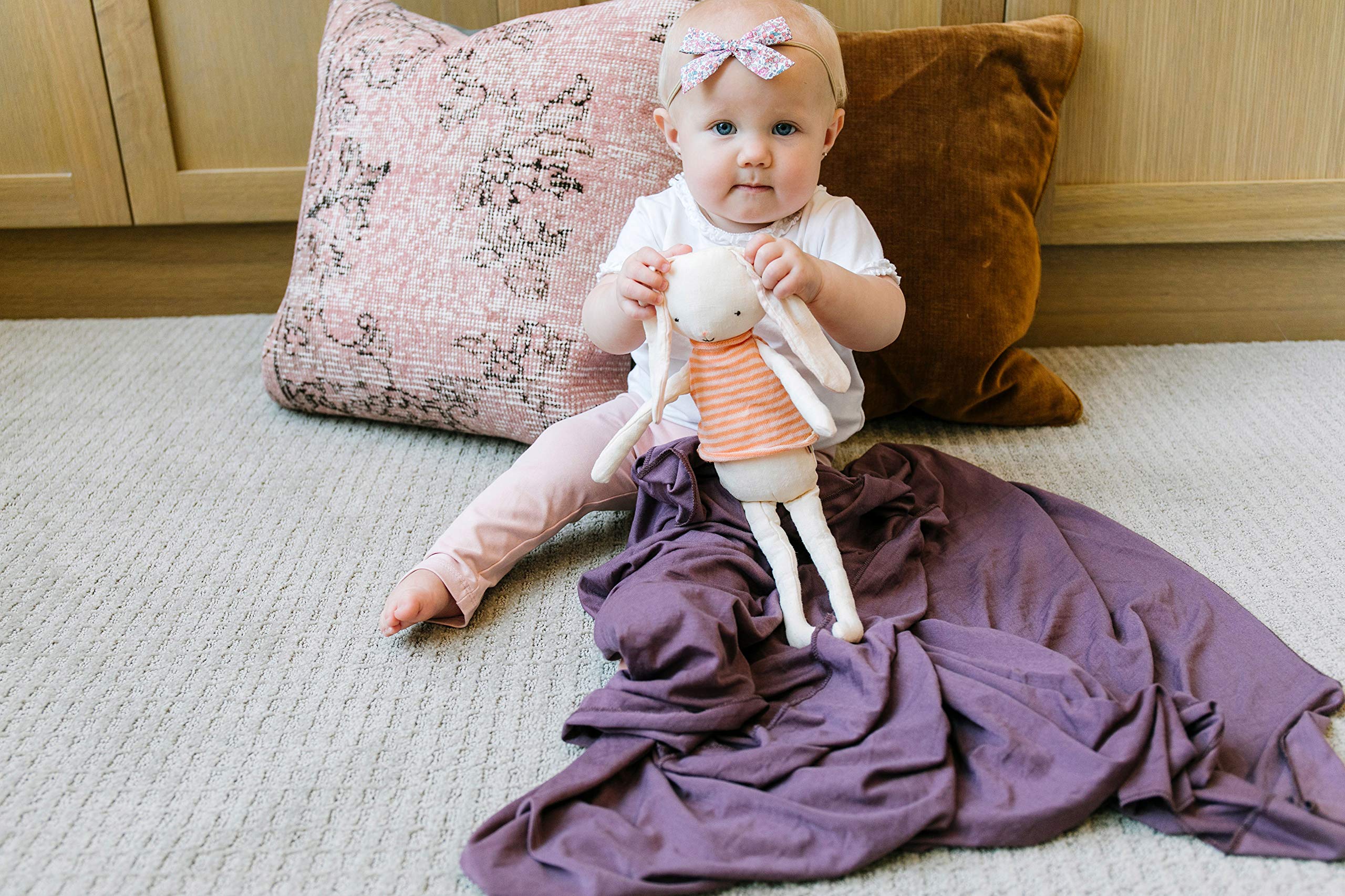 Copper Pearl plum swaddle blanket is machine-washable for easy care.