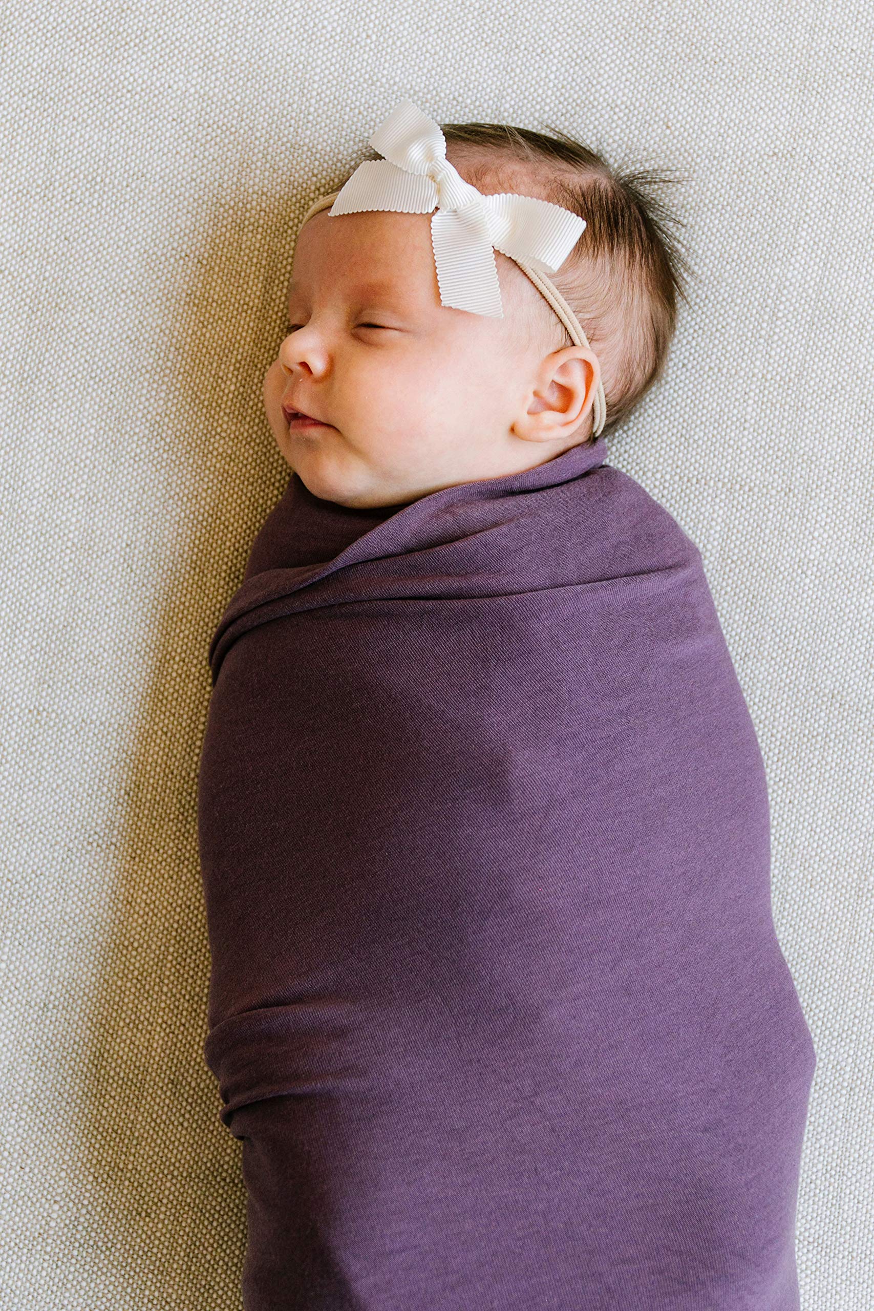 Copper Pearl plum swaddle blanket doubles as nursing cover and baby wrap.