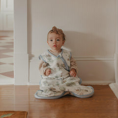 Copper Pearl Sleep Bag Hundred Acre Wood laid flat on crib showing three-layer knit softness.