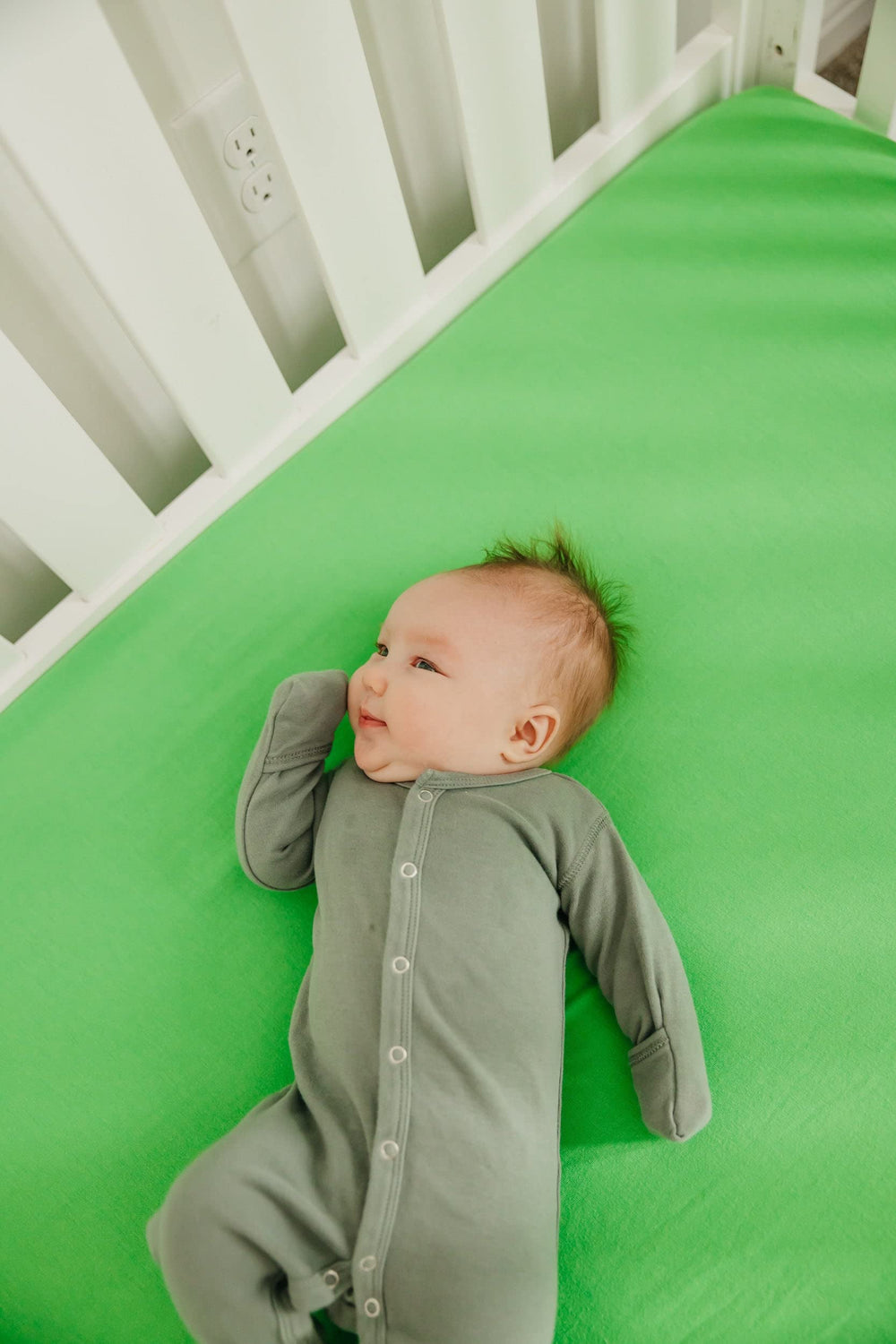 Copper Pearl premium knit crib sheet lime elastic stitches for a tidy, secure fit