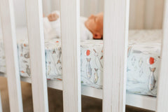 Copper Pearl Trout knit crib sheet on standard mattress in nursery